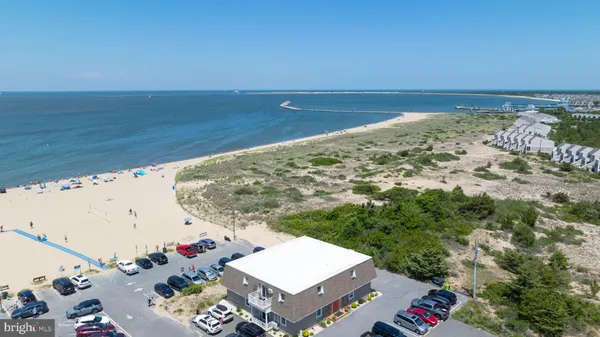 a view of a dry yard with wooden fence