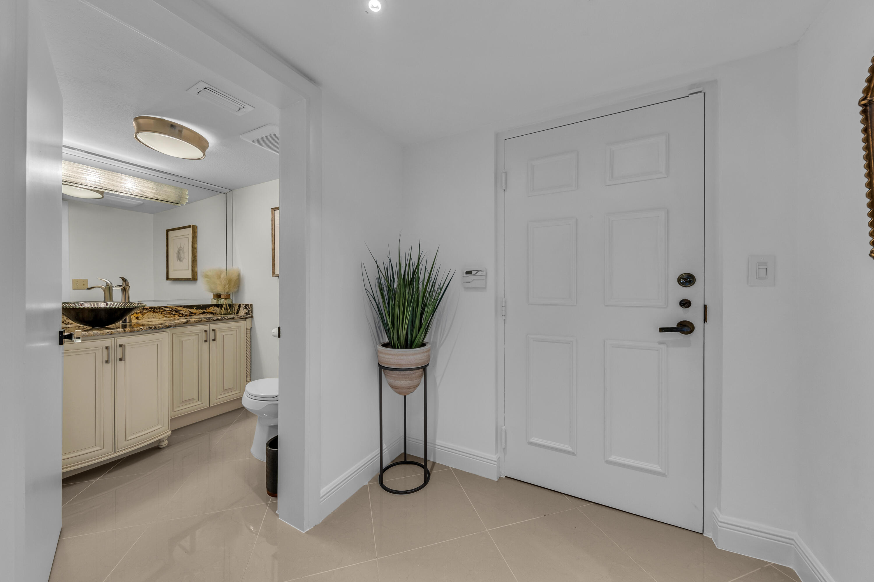 7572 Regency Lake Drive, Unit 402 Boca Raton, FL 33433 - Photo 9 of 31 Powder room at Entry