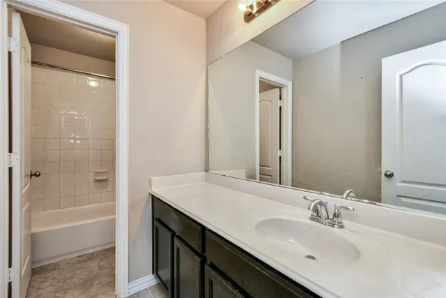 a white bath tub sitting next to a shower
