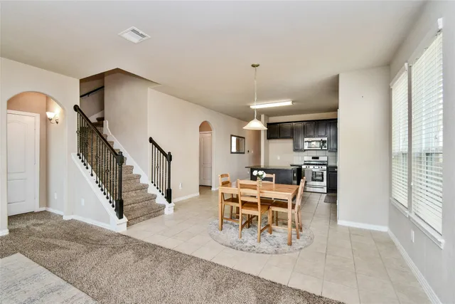 a view of a livingroom with furniture and staircase