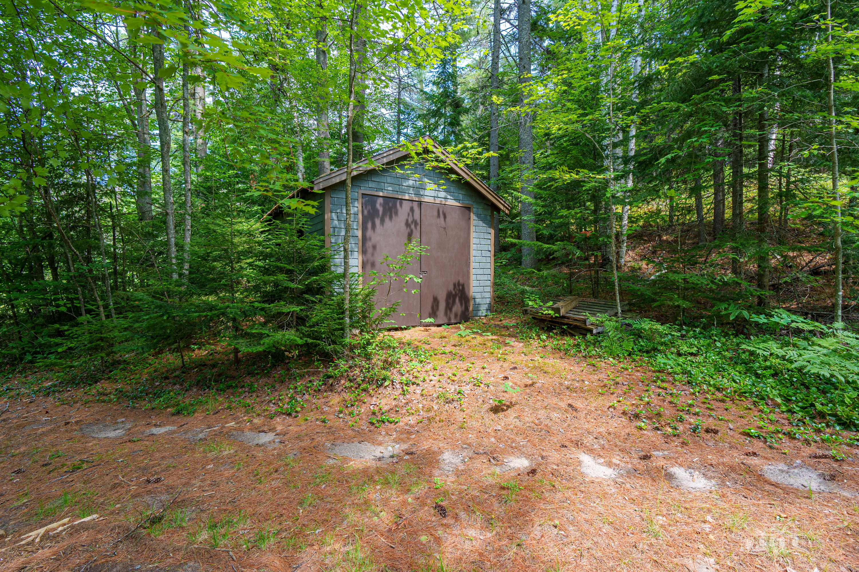 81 Hull Road Rainbow Lake, NY 12976 - Photo 49 of 62 One car garage with storage shed