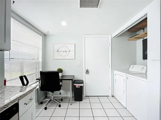 a bathroom with a granite countertop sink a toilet and a bathtub