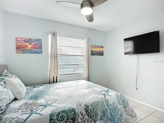 a view of a swimming pool with a patio and plants