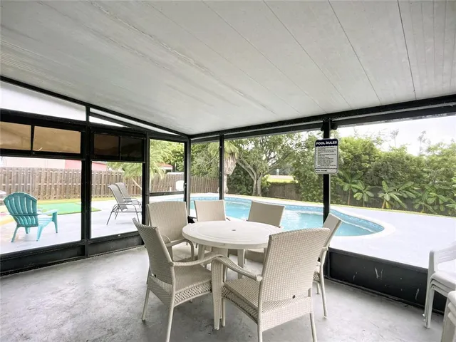 an aerial view of residential houses with outdoor space and swimming pool