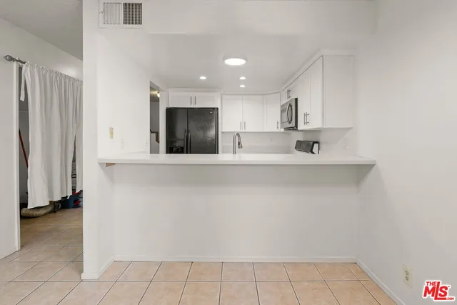 a kitchen with stainless steel appliances a stove sink and microwave