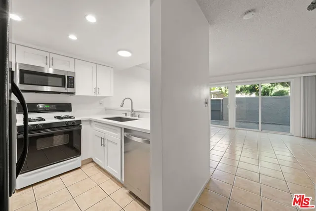 a kitchen with a sink appliances and cabinets