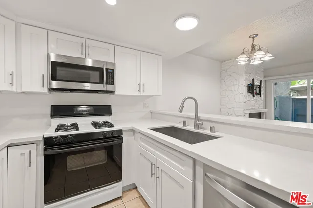 a view with a sink and chandelier