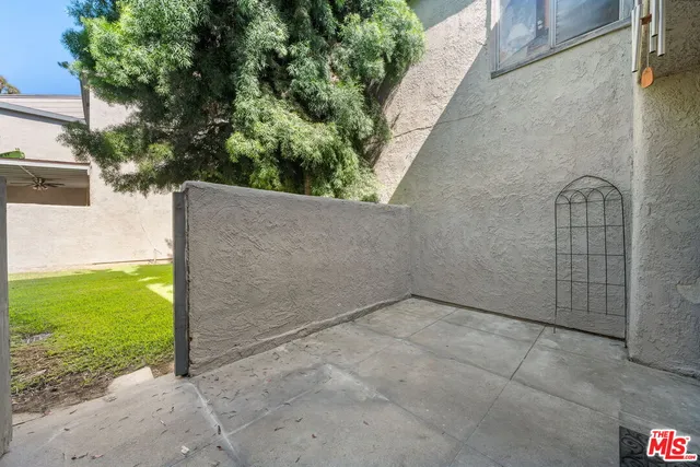 front view of house with a yard and potted plants