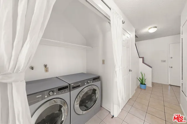 a view of a house with pool and chairs
