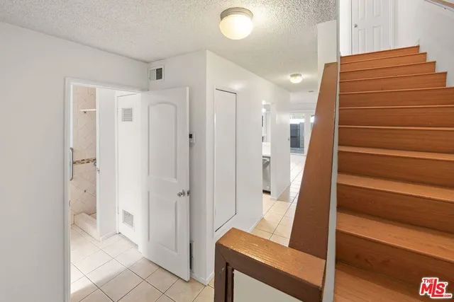 an empty room with fireplace and windows