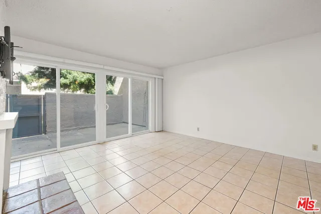 a view of a livingroom with an empty space and a fireplace