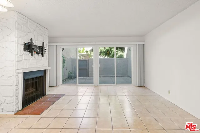 a living room with furniture a large window and a fireplace