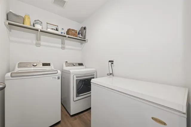 a view of a dining room with furniture wooden floor and a kitchen