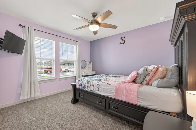 a bed sitting in a bedroom next to a lamp