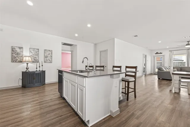 a kitchen with a table chairs refrigerator and cabinets