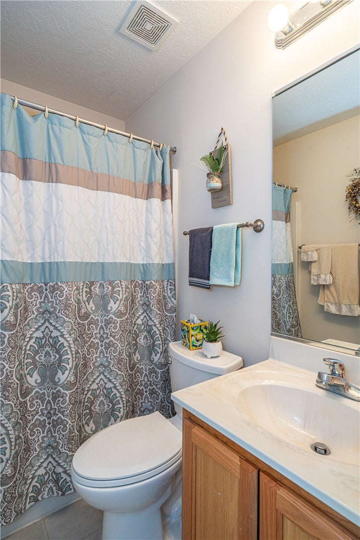 10765 Stone Ridge Way Harrison, OH 45030 - Photo 35 of 68 A well-maintained bathroom offers practicality with a shower-over-tub combination and an efficient vanity.