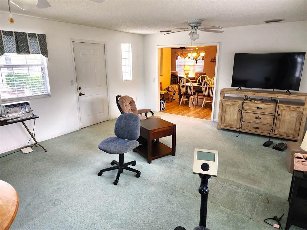 11660 Southwest 89th Terrace Ocala, FL 34481 - Photo 14 of 16 a living room with furniture and a flat screen tv