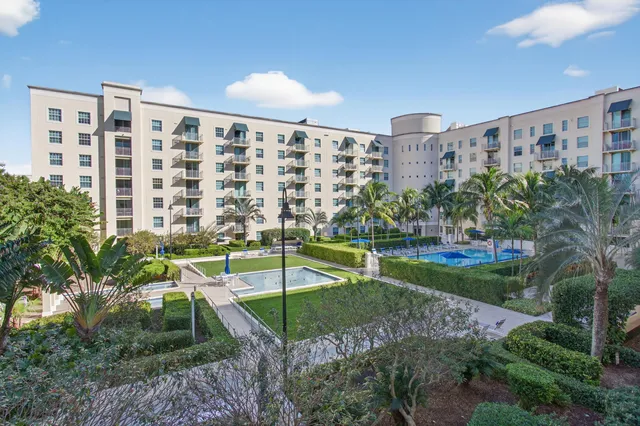 a view of a refrigerator in kitchen and an empty room