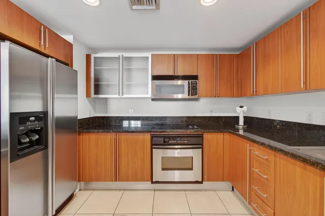 a view of an empty room with window and a ceiling fan