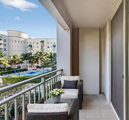 a view of a room with wooden floor and ceiling fan