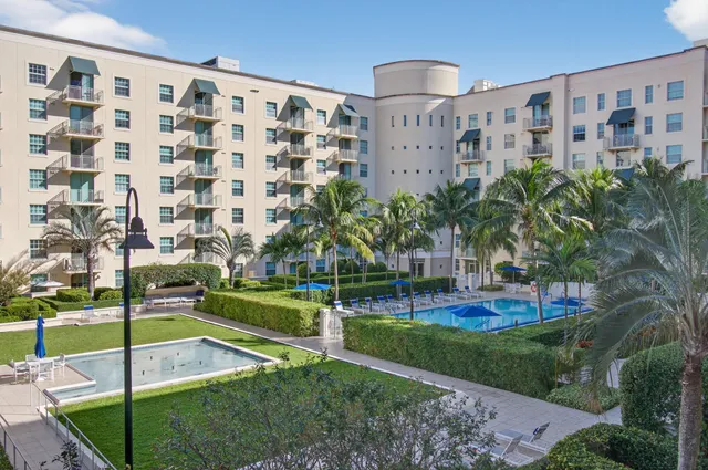 a bathroom with a granite countertop sink a toilet a mirror and shower