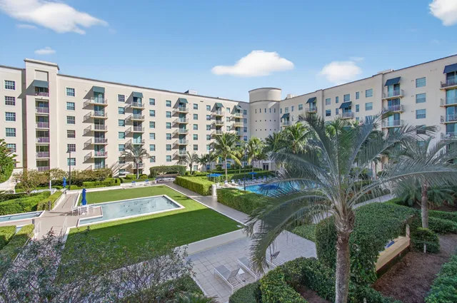 an empty room with wooden floor and a ceiling fan