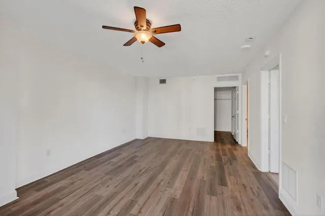 a view of living room with furniture and a clock