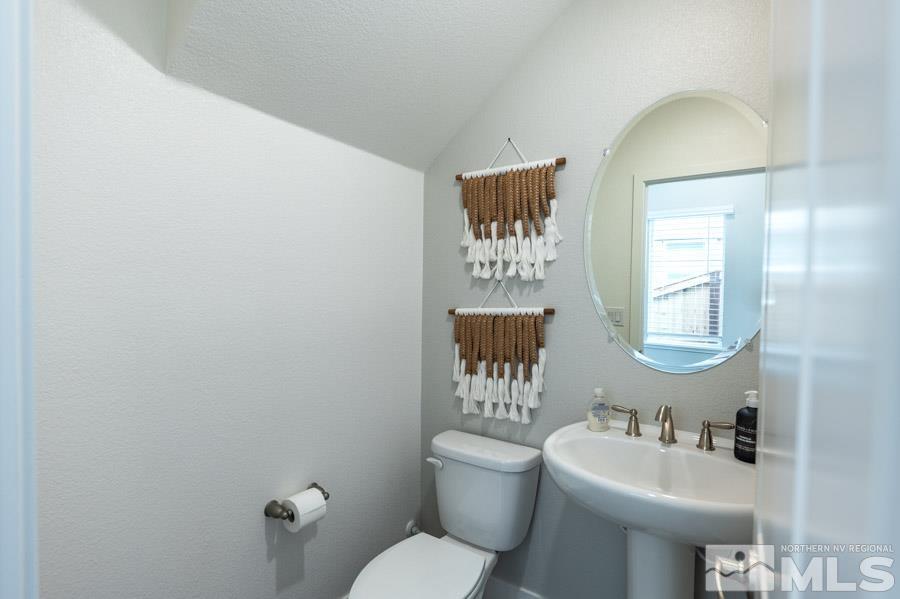 7814 Wandering Way, Unit LOT #167 Reno, NV 89506 - Photo 17 of 18 a bathroom with a toilet sink and mirror