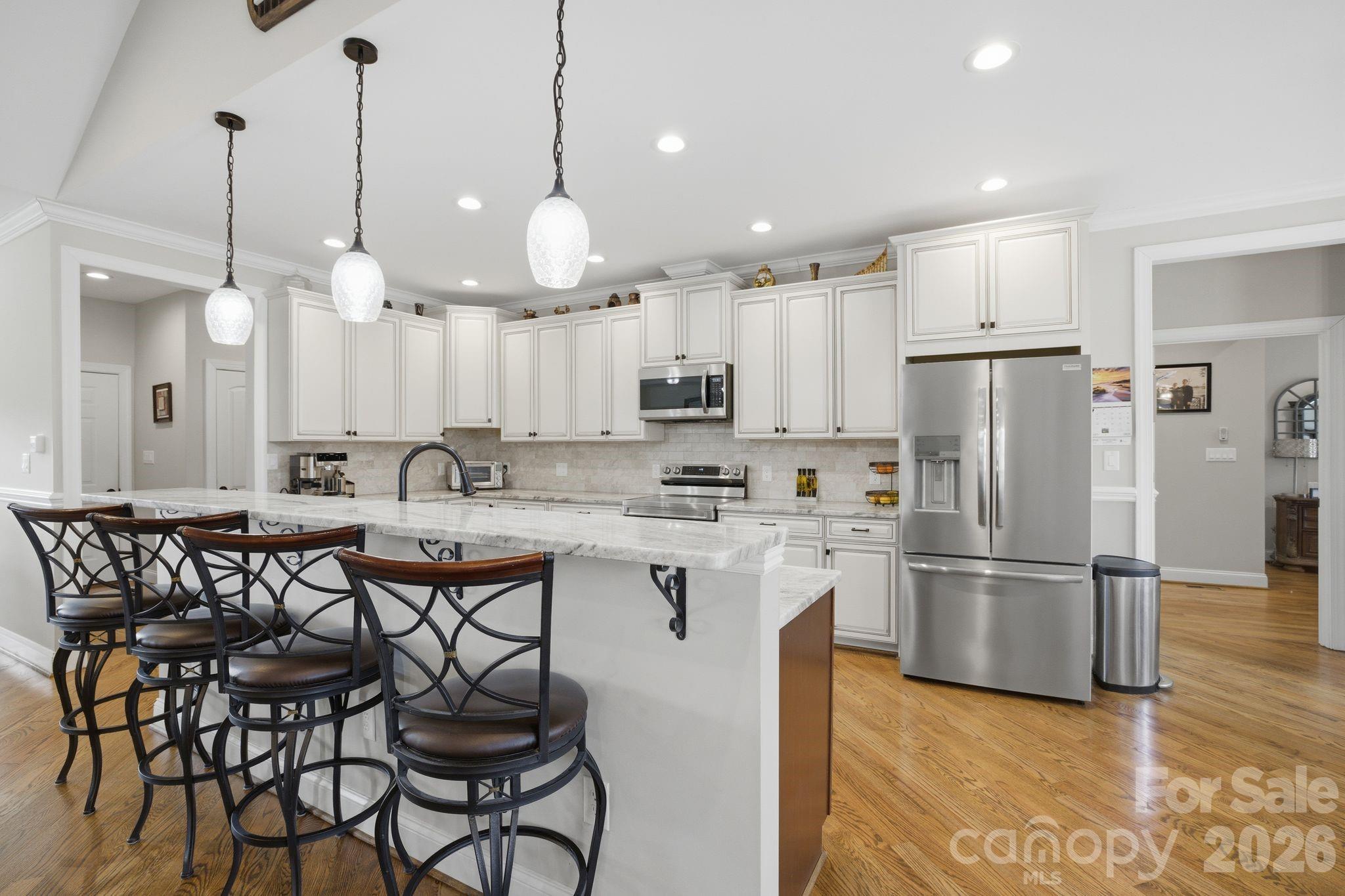 1370 Null Road, Unit 4 Lincolnton, NC 28092 - Photo 16 of 47 a kitchen with stainless steel appliances a refrigerator a stove a sink and white cabinets with wooden floor