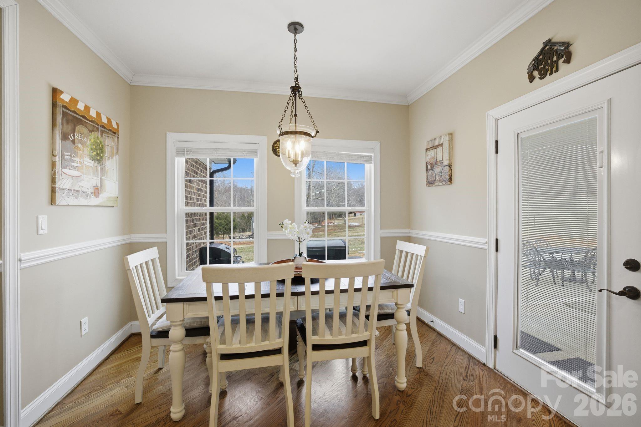 1370 Null Road, Unit 4 Lincolnton, NC 28092 - Photo 19 of 47 a dining room with furniture a chandelier and wooden floor