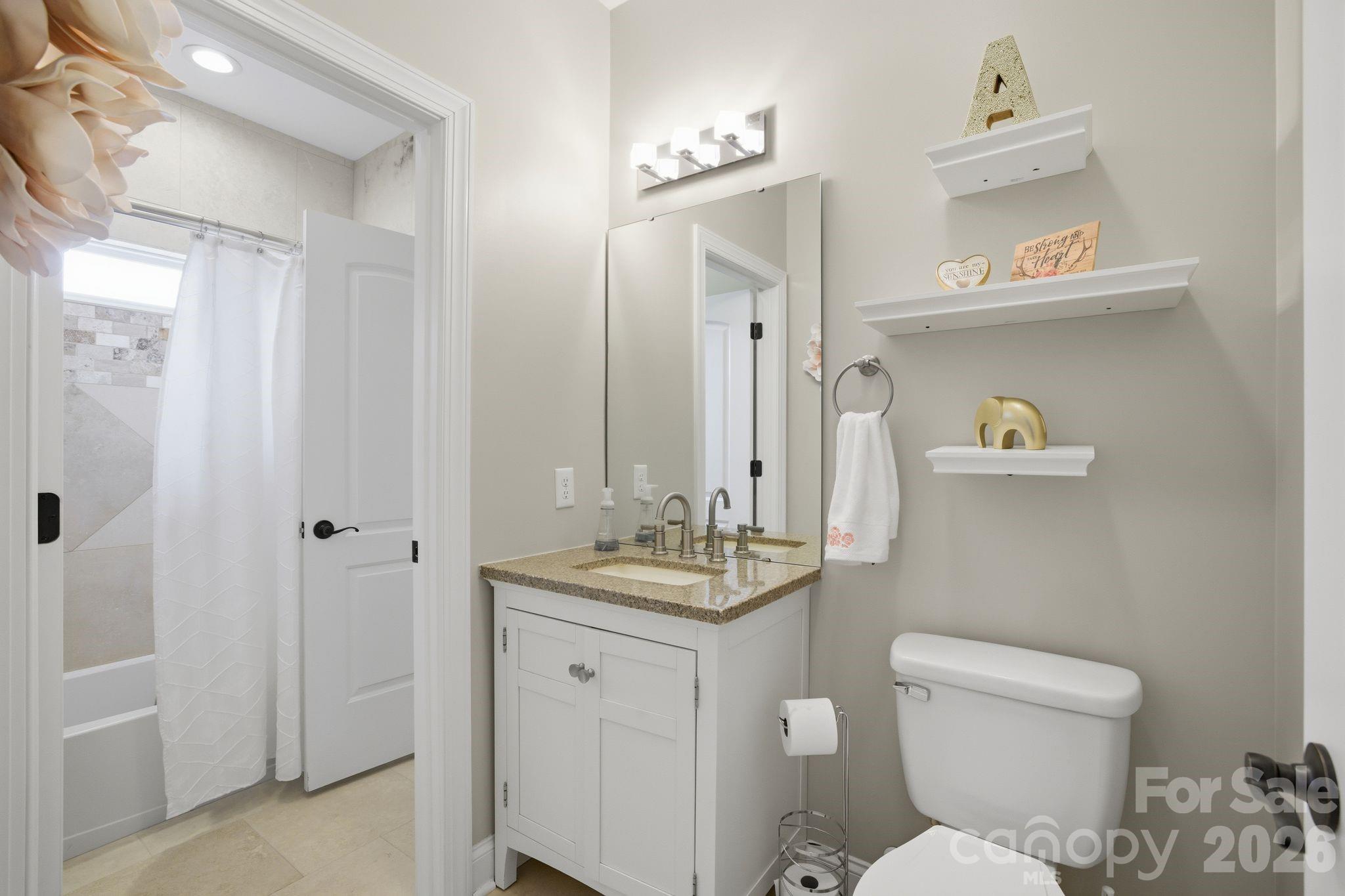 1370 Null Road, Unit 4 Lincolnton, NC 28092 - Photo 30 of 47 a bathroom with a granite countertop toilet sink and mirror