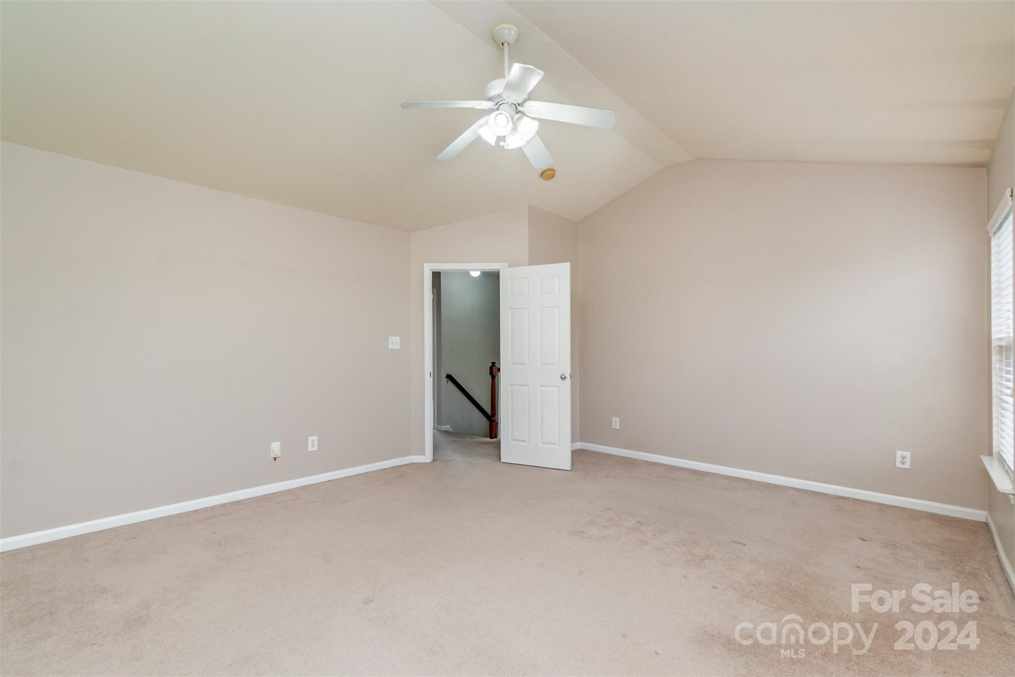 3320 Burnage Hall Road Harrisburg, NC 28075 - Photo 12 of 21 an empty room with a fan & a ceiling fan