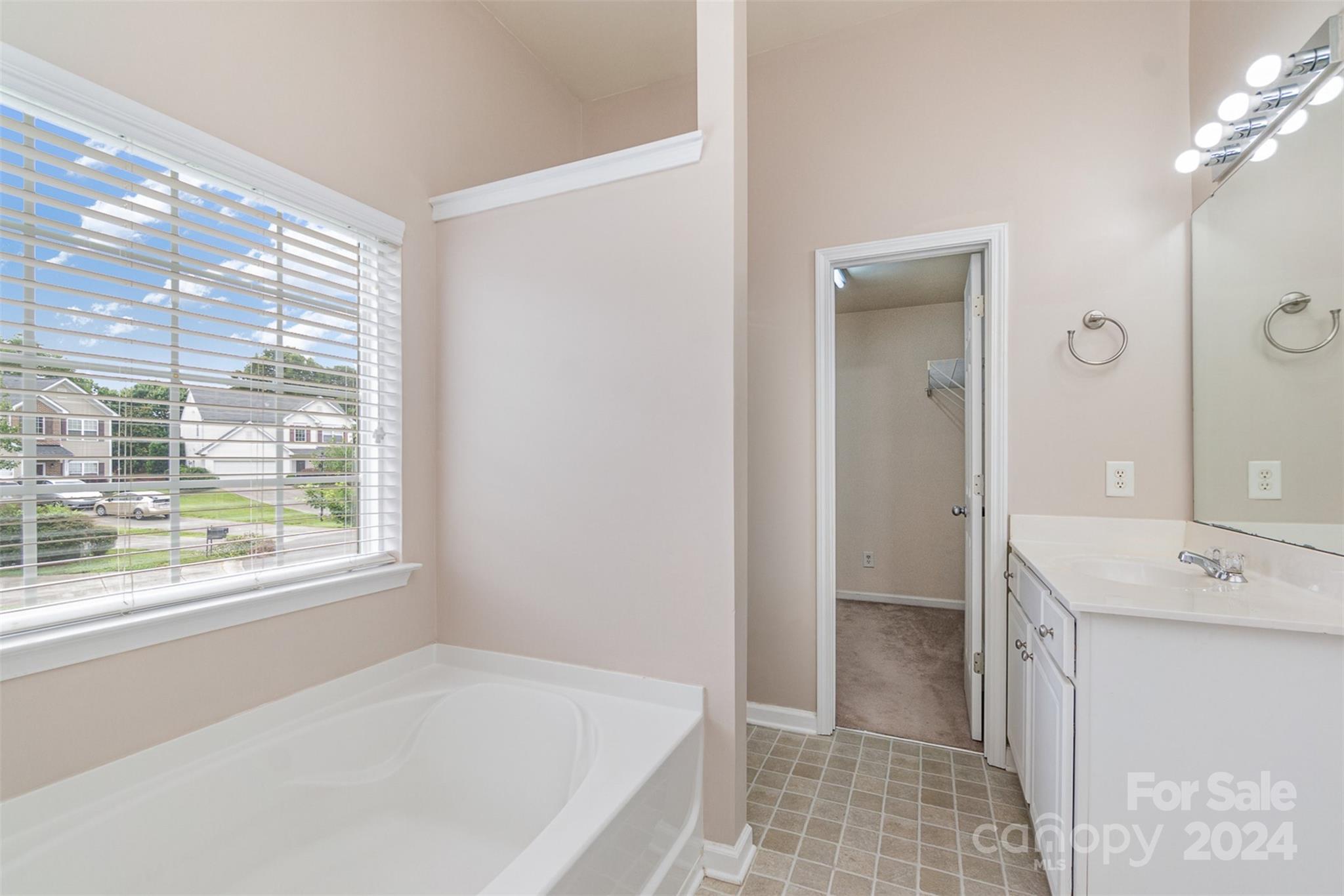 3320 Burnage Hall Road Harrisburg, NC 28075 - Photo 13 of 21 a bathroom with a tub sink and shower