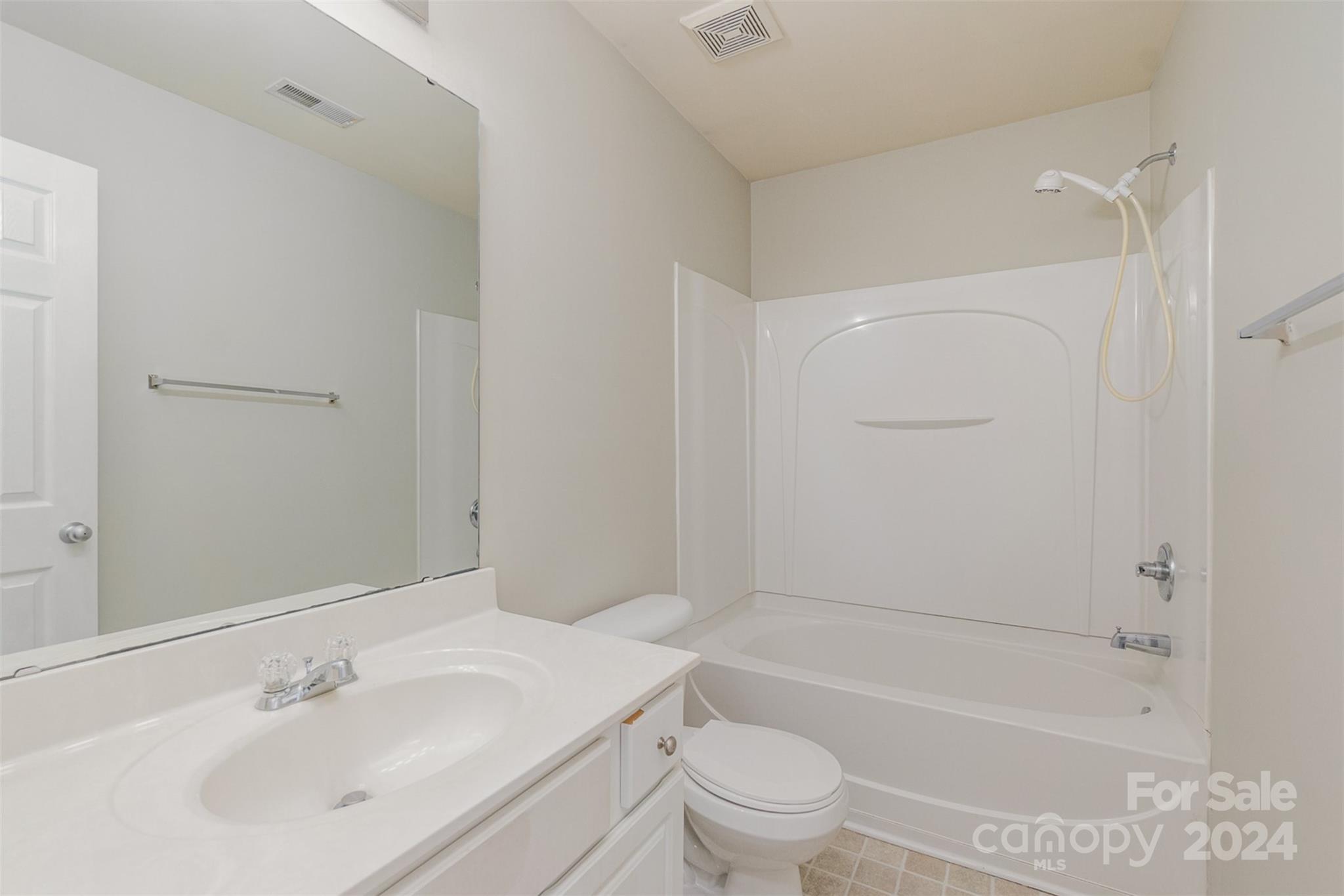 3320 Burnage Hall Road Harrisburg, NC 28075 - Photo 18 of 21 a bathroom with a bathtub shower sink vanity mirror and toilet