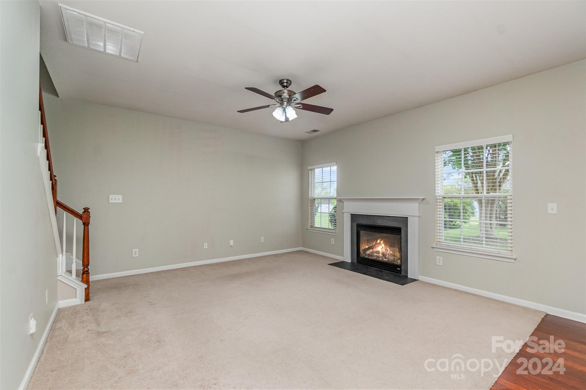 3320 Burnage Hall Road Harrisburg, NC 28075 - Photo 2 of 21 an empty room with windows and fireplace