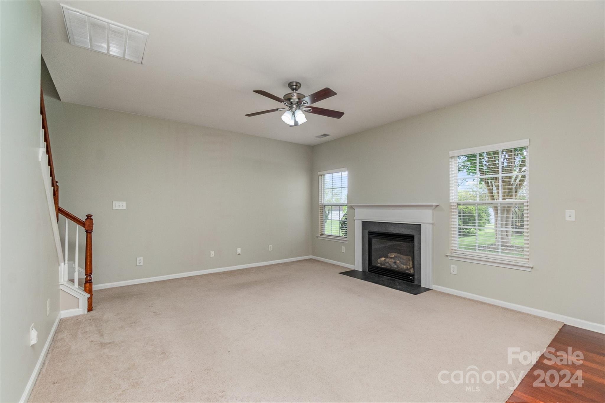 3320 Burnage Hall Road Harrisburg, NC 28075 - Photo 3 of 21 an empty room with fireplace and windows