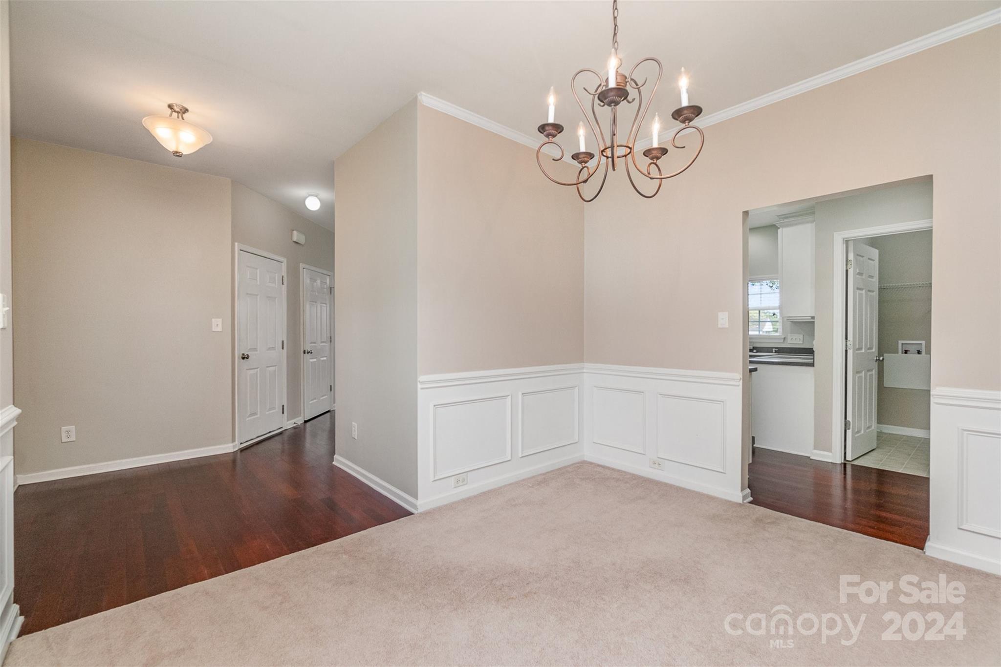 3320 Burnage Hall Road Harrisburg, NC 28075 - Photo 5 of 21 en empty room with chandelier and wooden floor