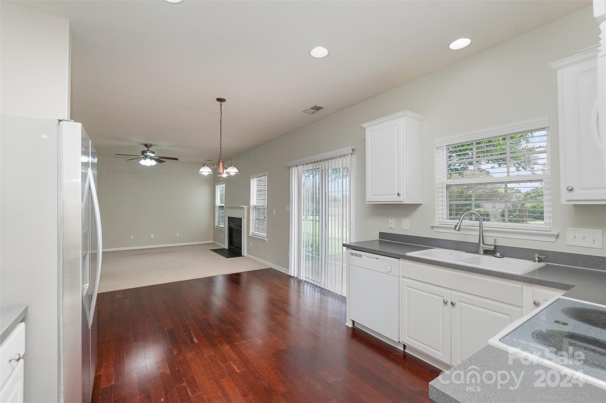 3320 Burnage Hall Road Harrisburg, NC 28075 - Photo 7 of 21 a kitchen with a sink window and cabinets