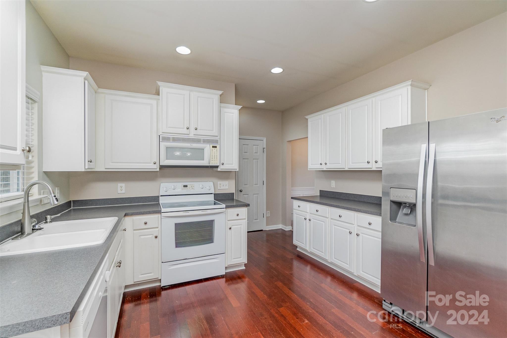 3320 Burnage Hall Road Harrisburg, NC 28075 - Photo 8 of 21 a kitchen with a sink cabinets stainless steel appliances and a window