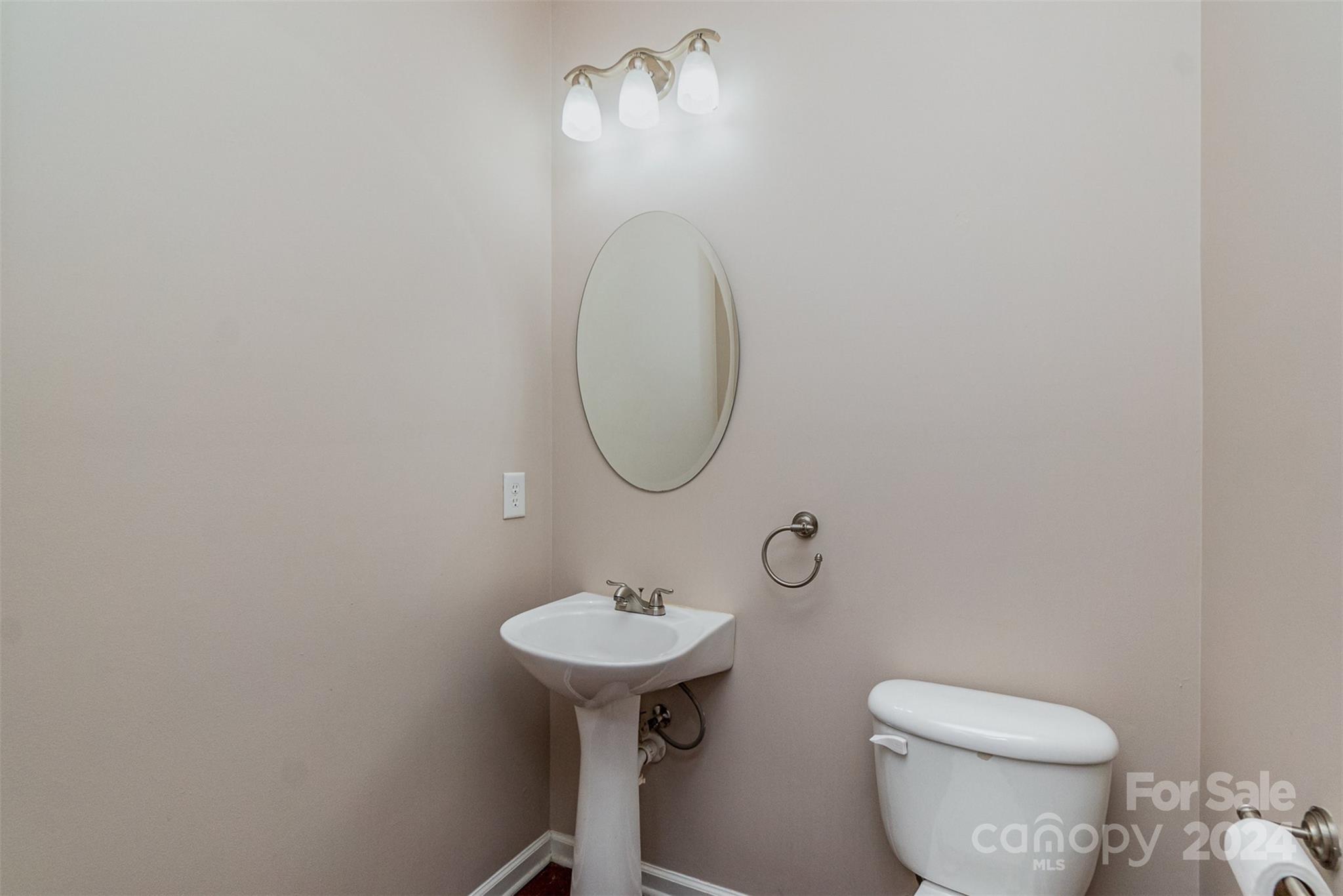 3320 Burnage Hall Road Harrisburg, NC 28075 - Photo 9 of 21 a bathroom with a toilet sink and mirror