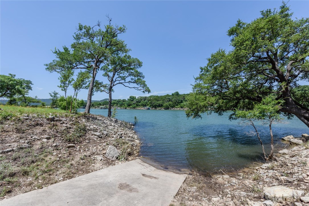 11008 Beach Road Leander, TX 78641 - Photo 1 of 1 a view of a lake with a house in the background
