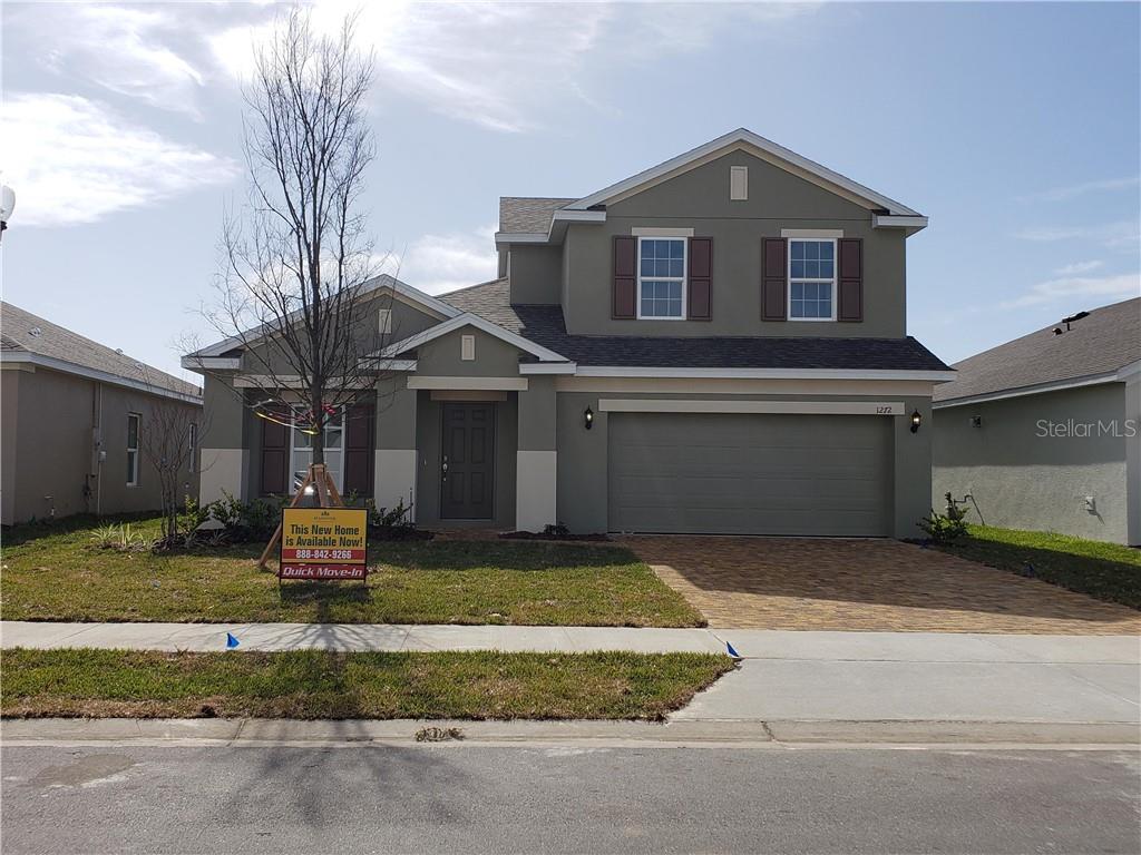 1272 Cavender Creek Road Minneola, FL 34715 - Photo 1 of 1 a front view of a house with a yard