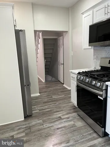 a kitchen with a stove and a microwave