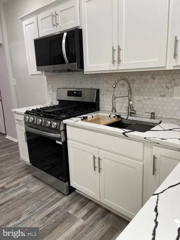 a kitchen with a stove and a microwave