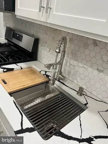a stove top oven sitting inside of a kitchen