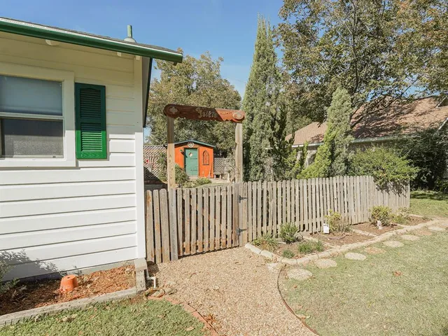 a view of a backyard with a fence