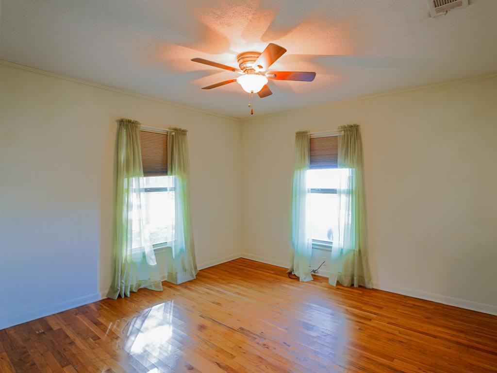 438 South Street Krum, TX 76249 - Photo 9 of 22 Bedroom with light wood finished floors, crown molding, and a ceiling fan