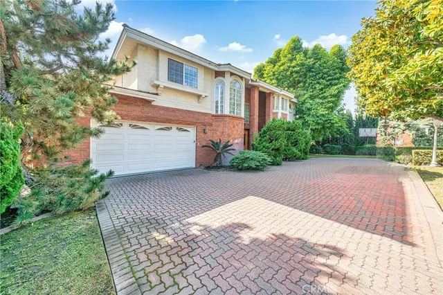 a front view of a house with a yard and a garage