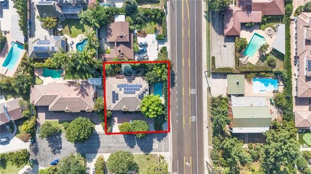 an aerial view of a residential apartment building with a yard and table and chairs