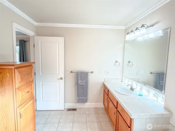 a spacious bathroom with a double vanity sink and a mirror